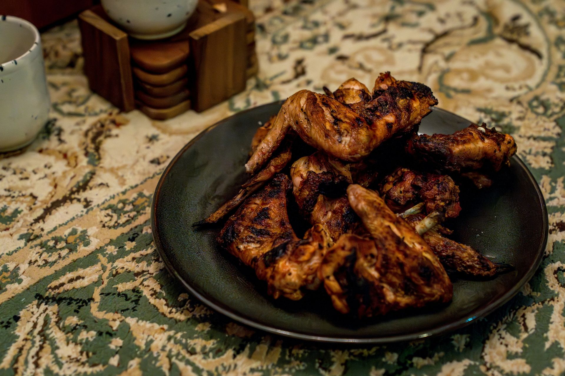 A plate of chicken wings on a table